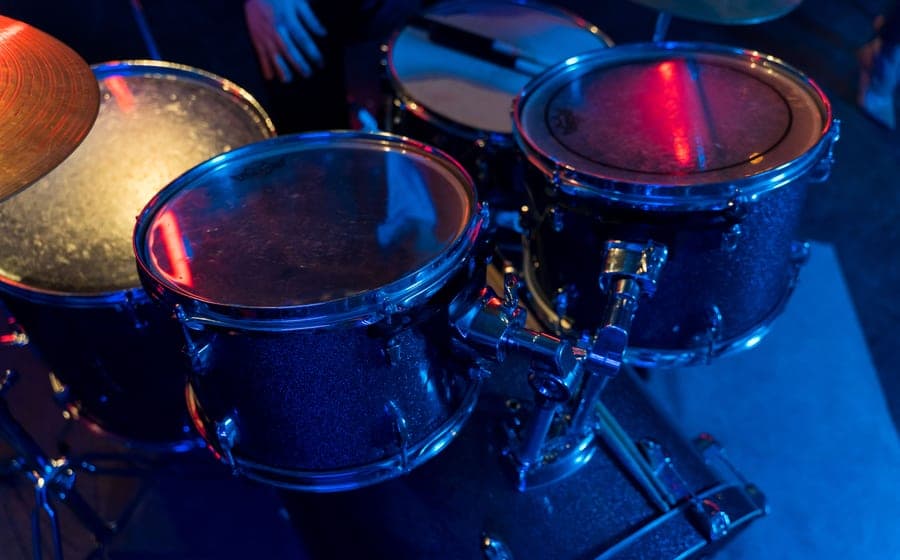 An acoustic drum kit with snare and cymbals in a room