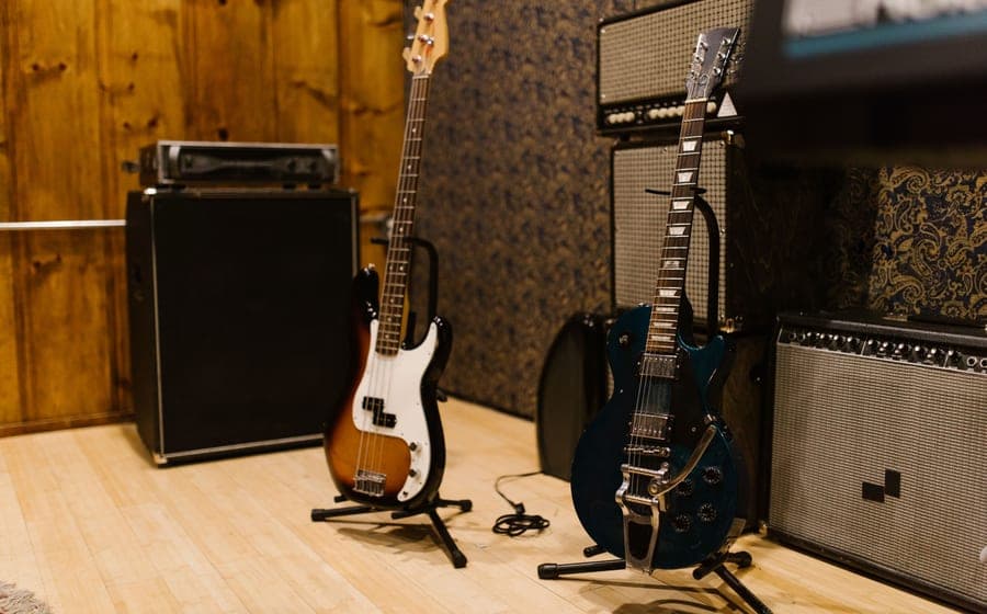 An electric guitar on a stand in a warmly lit room