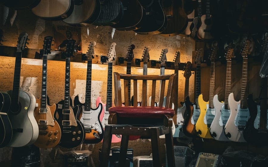 An electric bass guitar leaning against an amplifier
