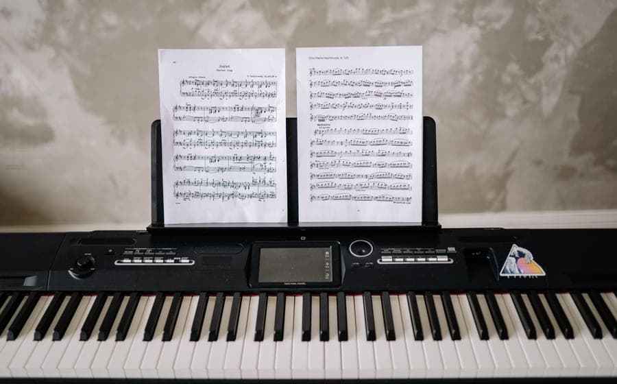 A digital piano set up against a wall in a home living room