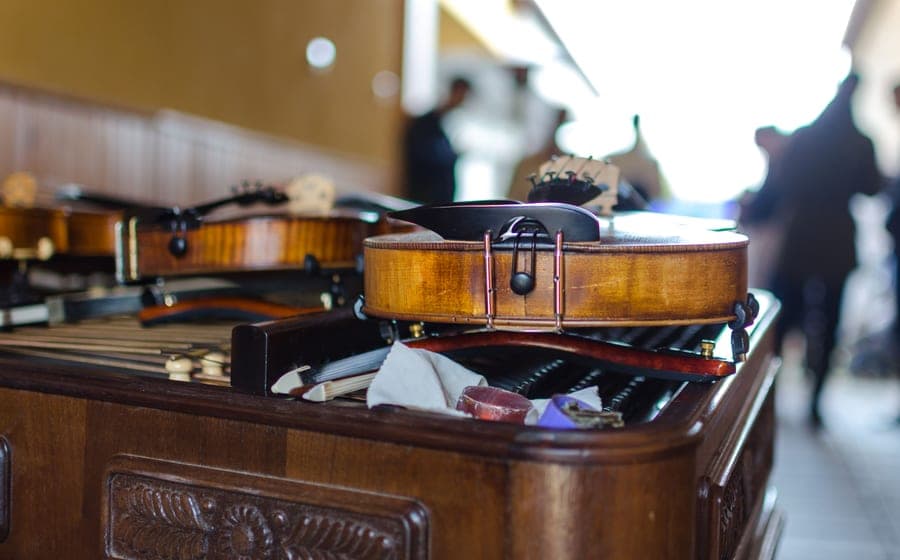 A guitar, a ukulele and sheet music laid out on a wooden table