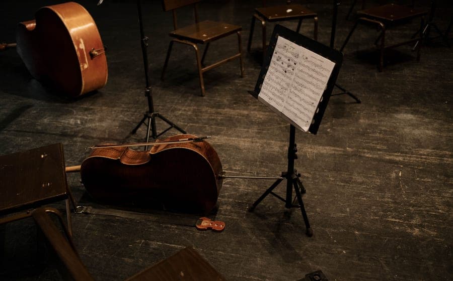 A violin and bow resting on a chair in warm daylight